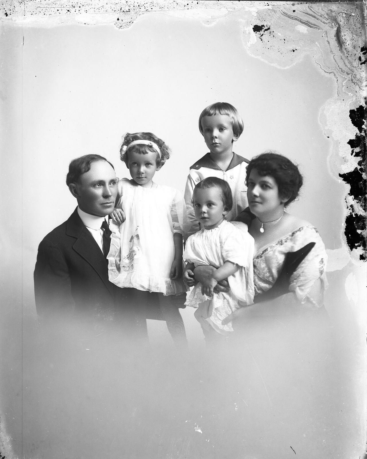 Before: Family portrait, parents with three children. Original glass plate negative is from the J. C. Knowles Collection, PhC.182, State Archives of North Carolina. (8720643985).jpg